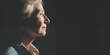 © J. Grayscale - Elderly woman in profile under dramatic lighting, evoking deep thought and quiet reflection, with strong contrasts in shadow