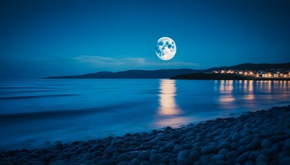 Moonlit beach town under a starry sky with gentle waves lapping at the shore