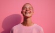 © Riya - smiling person with bald head against pink background
