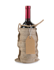 Poster - Wine bottle in burlap bag with cardboard tag isolated on white