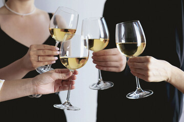 Canvas Print - People clinking glasses of wine indoors, closeup