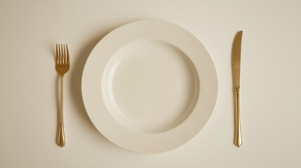 a white plate with a fork and knife on either side.