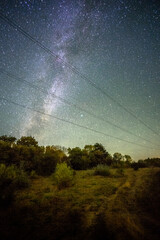 Wall Mural - Space with galaxy . Milky way on the blue sky .Dark and cold night at summer . Trees on the backgound with stars . Power lines in the night , powerstation and galaxy