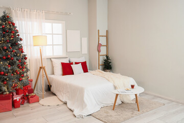 Sticker - Interior of festive bedroom with cozy bed and gifts under Christmas tree