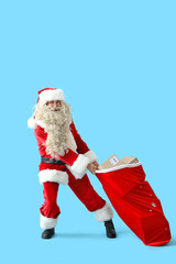 Poster - Santa Claus carrying heavy bag of gifts on blue background