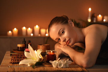 Poster - Beautiful young woman relaxing in dark spa salon, closeup