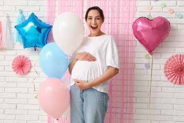 Canvas Print - Beautiful happy pregnant woman with balloons on white brick background. Gender reveal party concept