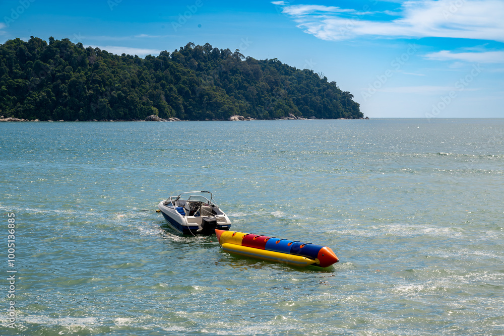 This vibrant image captures the thrill and excitement of a banana boat ...