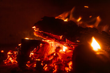 Home fireplace with red flame fire burns