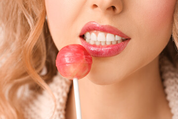 Poster - Young woman with beautiful lipstick and lollipop, closeup