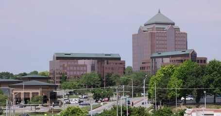 Wall Mural - Overland Park, Kansas, USA - June 17, 2023: Morning light shines on the buildings of the downtown city skyline.