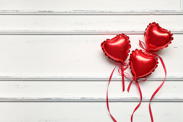 Wall Mural - Heart-shaped balloons for Valentine's Day on light wooden background