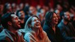 © Morng - Engaged audience laughing and enjoying a live performance in a packed theater, capturing the joy and energy of the event.