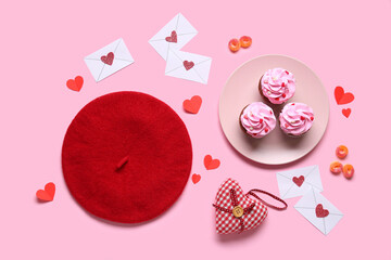 Wall Mural - Red beret with cupcakes and decor on pink background. Valentine's Day celebration