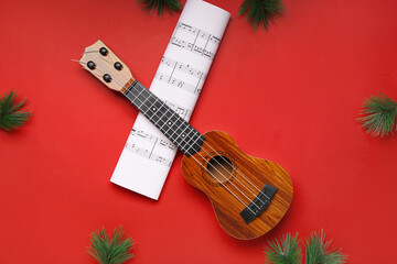 Poster - Composition with ukulele, music sheet and fir branches on red background