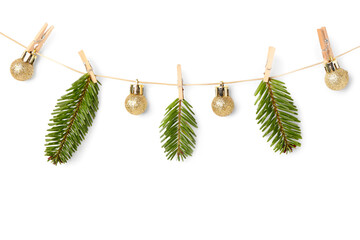 Wall Mural - Rope with Christmas tree branches, balls and clothespins on white background