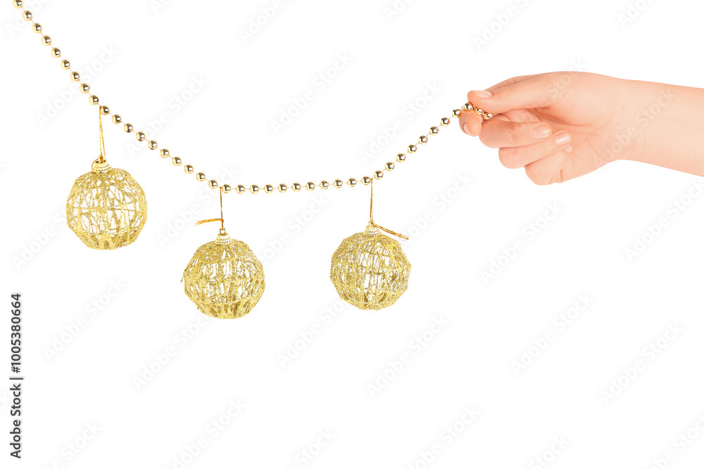 Female hand with beads and Christmas balls on white background