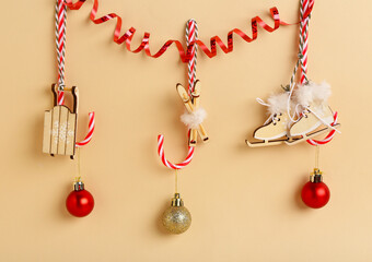 Beautiful Christmas decorations hanging on color background