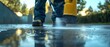 © Nattapat - Individuals cleaning a concrete driveway with a pressure washer, low angle perspective, highpressure water spray on hard surface, vibrant and clear image, 4K quality