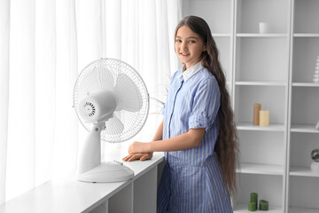 Sticker - Teenage girl looking out window near electric fan in living room