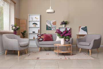 Poster - Modern interior of living room with lilac flowers in vase