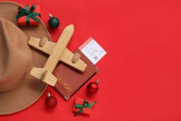 Sticker - Christmas toys, passport, ticket and hat on red background. Vacation concept