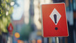 © ceng - A red warning sign with a white diamond and an exclamation point in the city.
