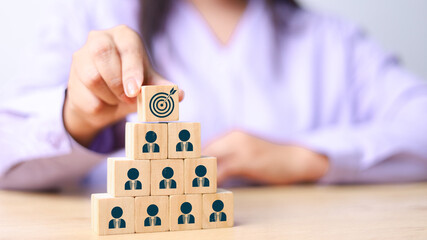 Wall Mural - target icon on the top of wooden cube blocks. with human icon for customer focus target group and cu