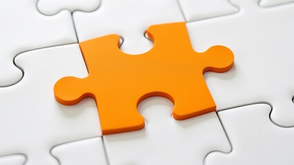 Picture of an orange puzzle piece that fits into a white puzzle. Teamwork, solutions, and problem-solving concepts are emphasized