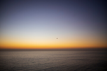 Wall Mural - sunset over the sea and a small plane