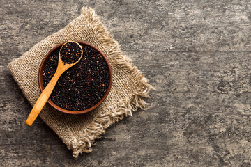 Wall Mural - quinoa seeds in bowl and spoon on colored background. Healthy kinwa in small bowl. Healthy superfood