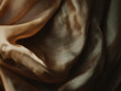 © VicenSanh - A piece of fabric with a gold and brown color. The fabric is folded and has a shiny texture
