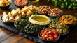 © ruangrit19 - Delectable Mediterranean Mezze Platter with Artful Presentation on Elegant Black Stone Dish