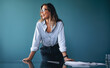 © Jacob Lund - Happy business woman stands in front of a conference table, ready to start a meeting with her team