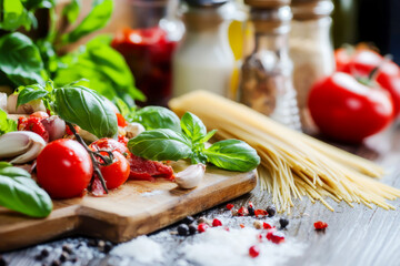 Wall Mural - a wooden cutting board with a variety of vegetables and spices on it. the vegetables include tomatoe