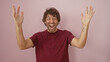 © Krakenimages.com - A cheerful young hispanic man with a beard laughing on a pink isolated background.
