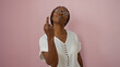 © Krakenimages.com - Woman showing middle finger in front of pink wall