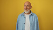 © Krakenimages.com - Handsome mature man with grey hair and beard smiling against an isolated yellow background
