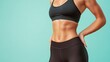 © Sumet - A fit woman in a sports bra showcases a toned abdomen, embodying health and fitness. Ideal for wellness and exercise concepts.