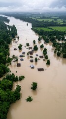 Aerial view of a flooded landscape with submerged houses and lush greenery, showcasing the impact of natural disasters on rural areas.