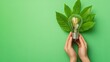 © Sumet - A light bulb surrounded by green leaves, symbolizing eco-friendly energy and sustainability on a vibrant green background.