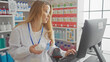 © Krakenimages.com - Blonde woman pharmacist working with medication bottle and computer in a drugstore