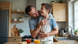 © Ali Hamza Tullah - Home, father and child with lifting for playing, laughing and connection for bonding together as family. Happy people, son and dad in kitchen for breakfast, cooking and parent with kid for carrying
