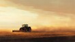 © Sampao - A tractor plowing a large, flat field on the plains, with dust rising behind it and the early morning sun illuminating the scene.