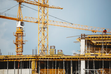 view of a construction site with buildings under construction and multi-storey residential homes.