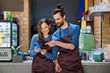 © Valerii Honcharuk - Young man and woman restaurant coffee shop workers using smartphone together