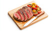 © Robert Kneschke - Sliced grilled steak with a knife and roasted vegetables on wooden board showcasing delicious gourmet meal presentation.
