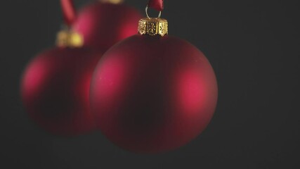 Wall Mural - christmas baubles hanging against black background. christmas decoration.