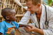 © Renata Hamuda - Humanitarian male doctor comforting African child during medical mission