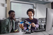 © ReeldealHD images - Happy students programming a robotic arm
